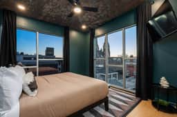 Bedroom 3 is on the 3rd floor, has a king bed and overlooks the rear yard and faces downtown.